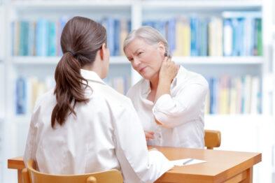 woman at the doctor getting a consultation about Parkinson's.