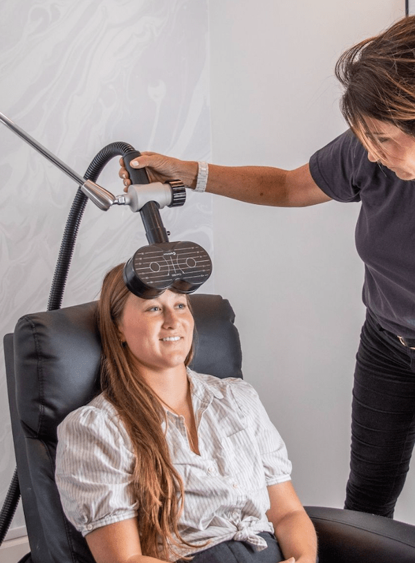 woman getting EEG-guided rTMS treatment for cognitive performance and mental health