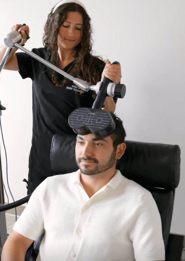 Man receiving EEG-guided rTMS treatment for cognitive performance and mental health