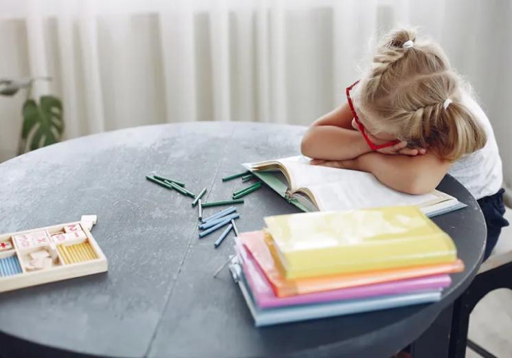 Child falling asleep at desk due to sleep and autism issues